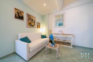 a living room with a white couch and a table at Victory's Luxury House with Jacuzzi on the Roof in Casamicciola Terme