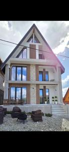a large house with a roof with windows at Cabana Bogdan Rânca in Ranca