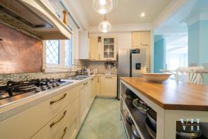 a kitchen with a stove and a refrigerator at Victory's Luxury House with Jacuzzi on the Roof in Casamicciola Terme +25 photos