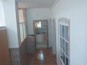an empty room with a kitchen and a hallway at Pieds dans l'Eau Douaouda in Fouka +4 photos