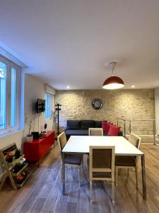a living room with a table and a couch at Au 47 in Bordeaux