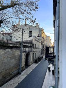 an alley in a city with an old building at Au 47 in Bordeaux