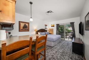 a bedroom with a bed and a desk and a kitchen at Morning Star Lodge - Hosted by Linda in Kellogg