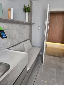 a small kitchen with a couch and a sink at Apê Calma - 5min Consulado EUA - Garagem in Porto Alegre +58 photos