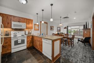 a kitchen with white appliances and a dining room at Morning Star Lodge - Hosted by Linda in Kellogg