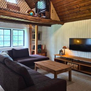 a living room with a couch and a coffee table at Scandinavian forest retreat in Ljungbyhed