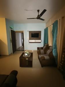 a living room with a couch and a table at Aura Vista in Bhopal