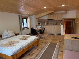 a bedroom with a large bed and a kitchen at Apartmán Lukáš in Ždiar