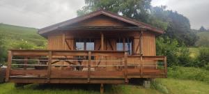 a small wooden house in the middle of a field at Wooden chalet with splendid view in Fresse-sur-Moselle
