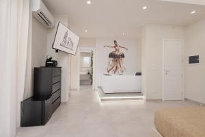 a bedroom with a statue of a woman on the wall at BellDuomo Suite Messina in Messina