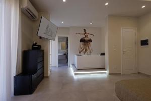 a bedroom with a dresser and a statue of a woman at BellDuomo Suite Messina in Messina +54 photos