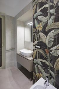 a bathroom with a wall mural of plants at BellDuomo Suite Messina in Messina