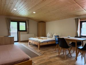 a bedroom with a bed and a table and chairs at Apartmán Lukáš in Ždiar
