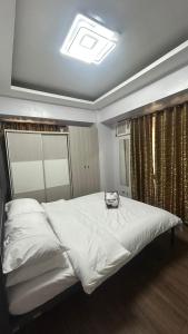 a bedroom with a large white bed in a room at Condo Unit at La Verti Residences in Manila +17 photos