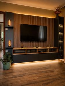 a living room with a television on a wall at Nature escape cottage in Cetinje