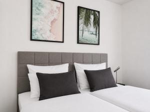 a bedroom with a bed with two pictures on the wall at Cosima in Hohenroth