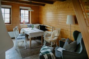 a dining room with a table and chairs at Komora Lužná in Lužná