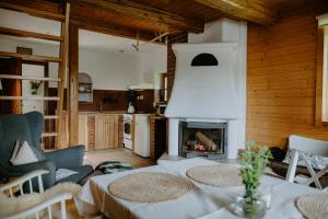 a living room with a table and a fireplace at Komora Lužná in Lužná