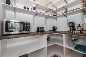 a kitchen with a microwave on a counter at Luxurious Villa Tremblant 4 Bdrs W Hot Tub B85 in Mont-Tremblant