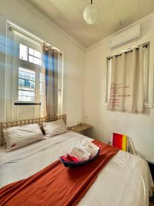 a bedroom with a bed with a bowl on it at Casa Igara Hostel in Belém