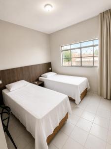 a hotel room with two beds and a window at Hotel Executivo formosa in Formosa