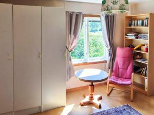 a small room with a pink chair and a window at 11 person holiday home in HÖGSÄTER-By Traum in Högsäter