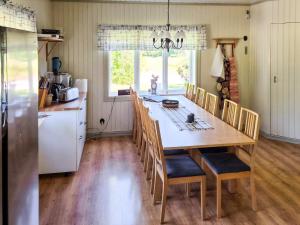 a kitchen and dining room with a table and chairs at 11 person holiday home in HÖGSÄTER-By Traum in Högsäter +28 photos