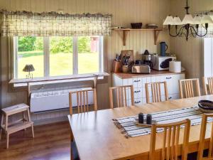 a kitchen with a wooden table and a dining room at 11 person holiday home in HÖGSÄTER-By Traum in Högsäter