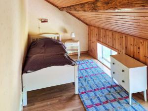a bedroom with a bed in a room with wooden walls at 11 person holiday home in HÖGSÄTER-By Traum in Högsäter