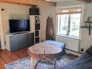 a living room with a table and a tv at 4 star holiday home in Uppsala-By Traum in Uppsala