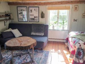 a living room with a couch and a table at 4 star holiday home in Uppsala-By Traum in Uppsala