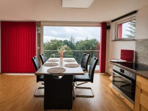 a kitchen with a table with chairs and a large window at Ski- und Wanderurlaub im Wald Ferienhaus Adlerblick in Schnett +40 photos
