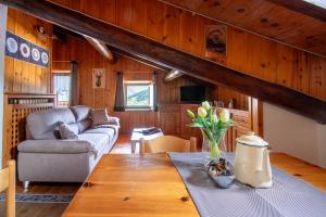 a living room with a couch and a table at The WoodHouse in Livigno