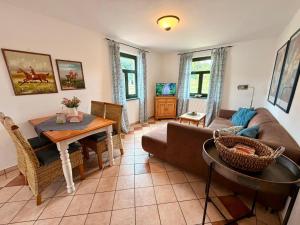 a living room with a couch and a table at Wohnung in Dargun mit Garten in Barlin