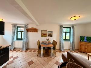a living room with a table and a couch at Wohnung in Dargun mit Garten in Barlin