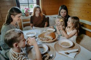 a group of children sitting around a table with a cake at Komora Lužná in Lužná