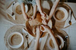 a table with cups of coffee and people holding their hands at Komora Lužná in Lužná +27 photos