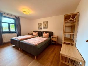 a bedroom with a bed and a book shelf at Großes Landhaus mit Swimmingpool in Dargun in Barlin