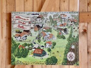 a map of a village on a wooden wall at Großes Landhaus mit Swimmingpool in Dargun in Barlin