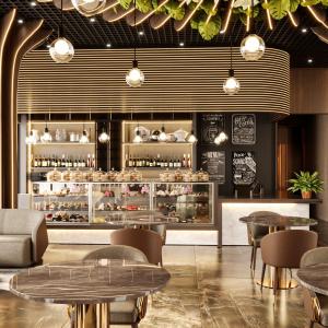 a restaurant with tables and chairs and a bakery at Aerohub Grand Hotel in Arnavutköy