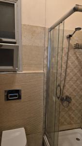 a bathroom with a shower with a toilet and a television at Ali Paşa Konağı Sarıyer in Sarıyer +39 photos