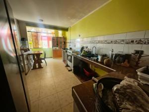 a kitchen with yellow walls and a counter top at APART TOSCANO Suites in Huancayo