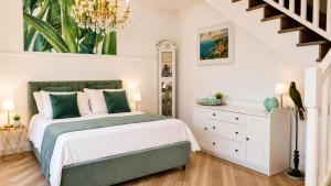 a bedroom with a bed and a chandelier at Villa Costanza sorrento B&b in Sant'Agnello