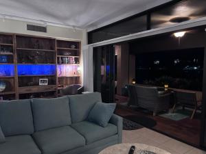 a living room with a couch and a television at Kaanapali Royal C102 in Lahaina