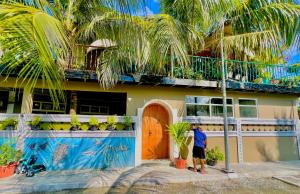 a man standing in front of a house at Koimala Hotel in Maamigili