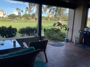 a patio with a table and chairs and a golf course at Kaanapali Royal C102 in Lahaina