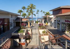 an empty street in a town with palm trees at Kaanapali Royal C102 in Lahaina