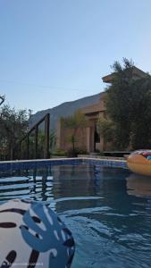 a swimming pool with a pool noodle in front of a house at Hikers place in Sutomore
