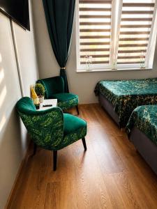 a room with two beds and a table and chairs at Premium Exclusive Suite in Nowy Dwór Mazowiecki