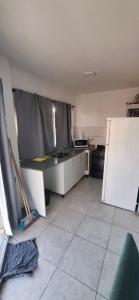 a kitchen with a sink and a refrigerator at Apartamento Monte Grande Ameghino in Monte Grande